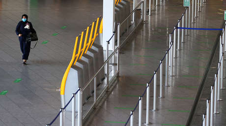 FILE PHOTO: Frankfurt's airport during COVID-19 FILE PHOTO: A passengers walks through the empty check-in area of German air carrier Lufthansa at the airport as the spread of coronavirus disease (COVID-19) continues in Frankfurt, German