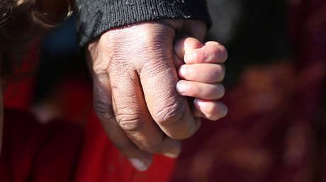 VIDEO: Una madre coge a su hijo por el cuello y lo usa como 'arma' para golpear a un hombre en la calle