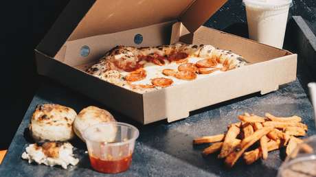 VIDEO: Asaltan a una mujer en una cafetería y su novio sale corriendo, pero ella se queda tranquilamente comiendo su pizza